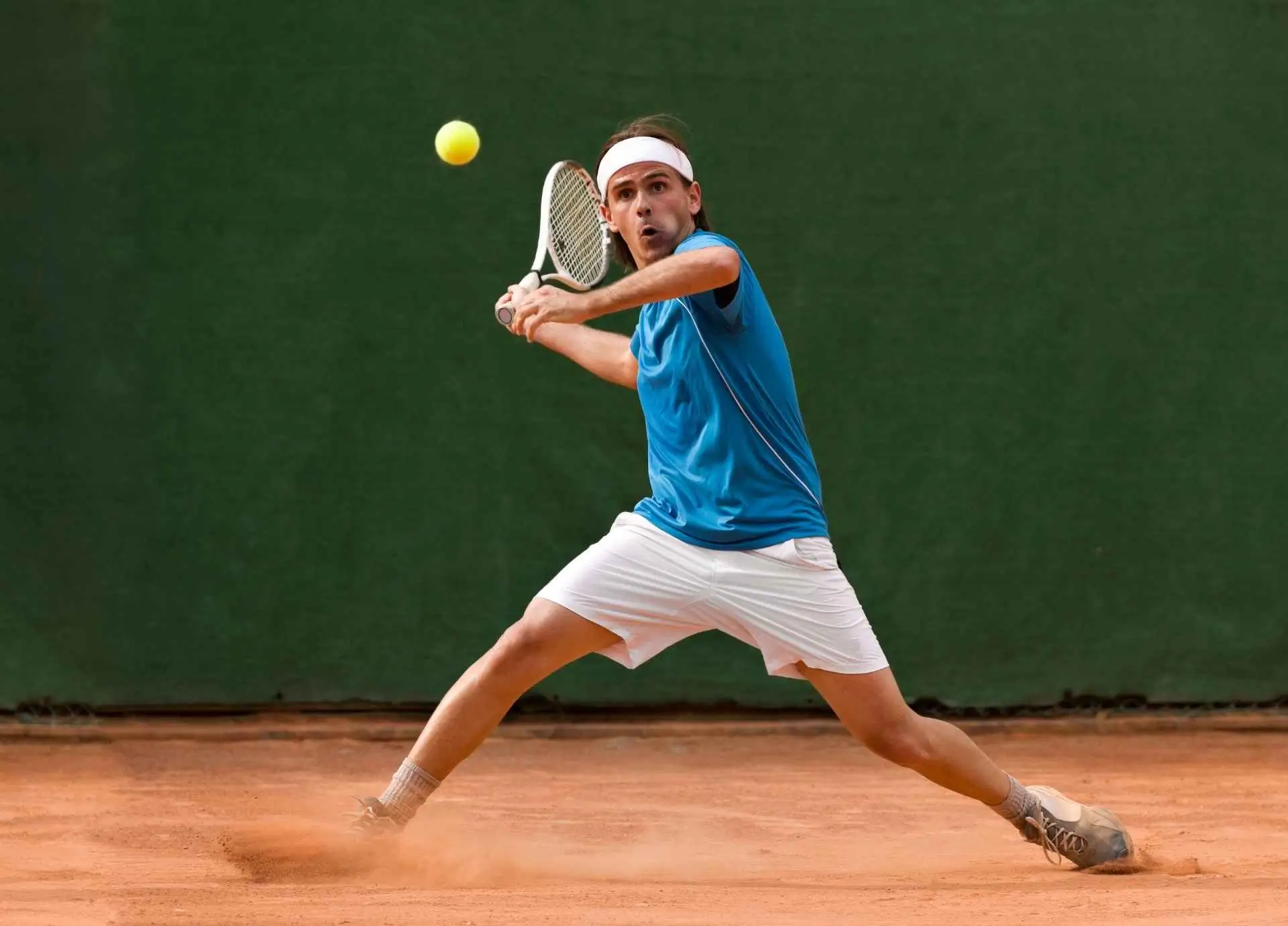Coach reviewing game strategy with volleyball players.