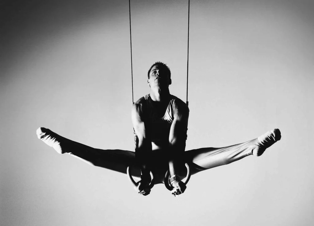 A white napkin on a rustic wooden table with the text "Your daily routine matters" written in blue, accompanied by a blue coffee mug and a silver pen.